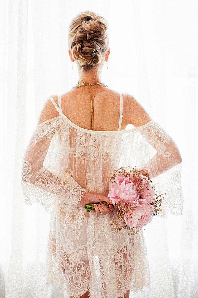 wedding boudoir book bride with updo in white lace holds a rose bouquet bridalboudoir via instagram